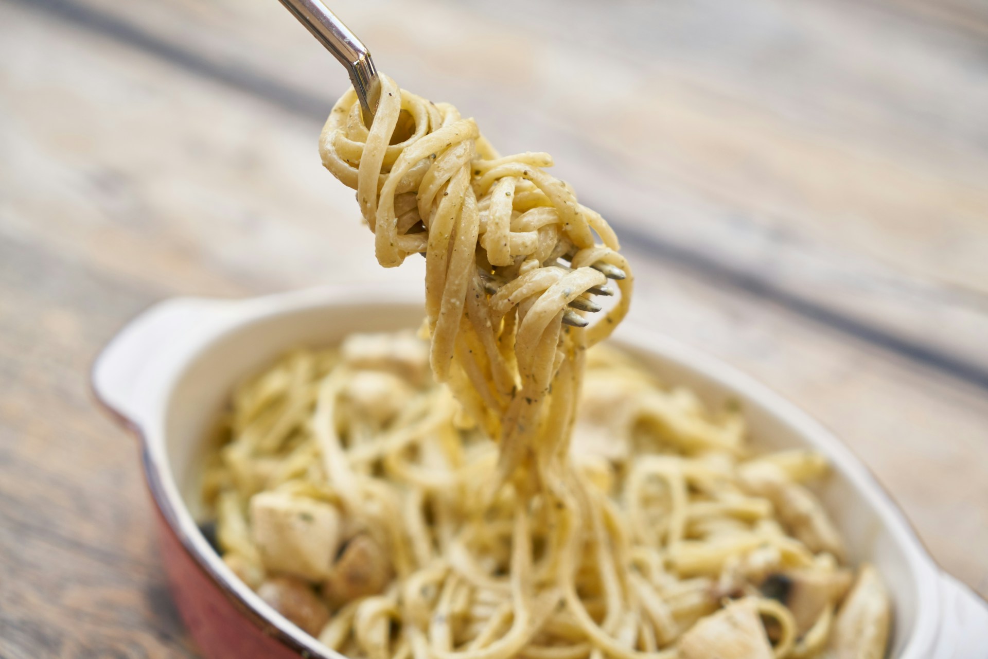 Creamy hand-tossed pasta on a fork